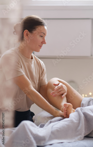 Foot spa massage treatment by professional massage therapist in luxury spa resort. Wellness, stress relief and rejuvenation concept