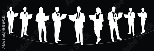 Business professionals silhouettes using laptops, standing together isolated on black background corporate concept