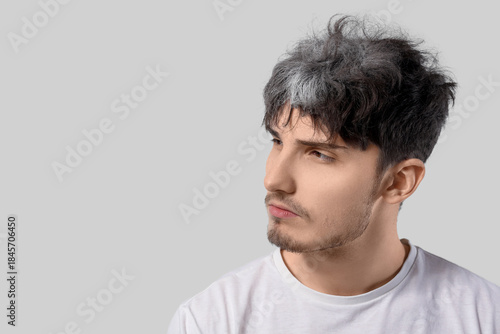 Young man with graying hair...