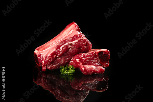 Fresh Raw Beef Steaks and Cuts on Black Background