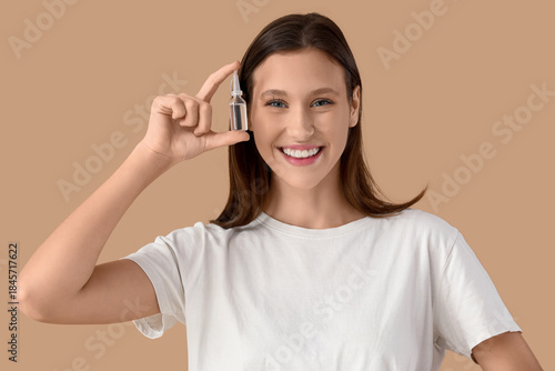 Young woman with eye drops ...