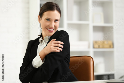 Young businesswoman hugging...