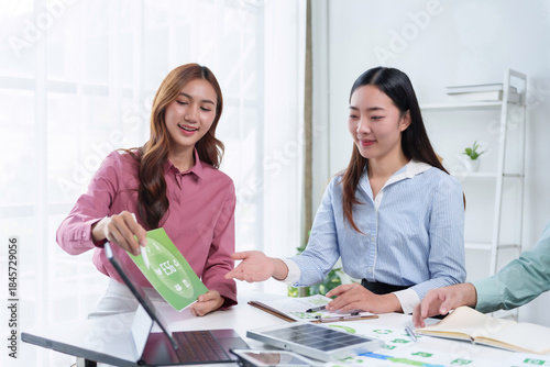 Businesswomen meeting about ESG strategy, green energy, and corporate sustainability at an office table with solar panel