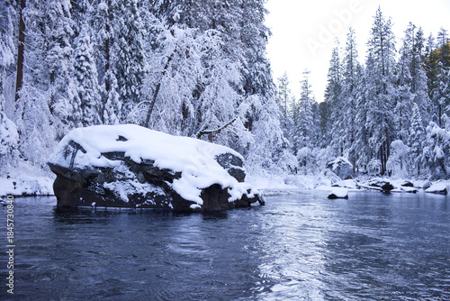 Snow covered rock in the river in Yosemite National Park at winter