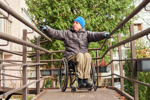 Wallpaper Mural a man in a wheelchair descends a ramp Torontodigital.ca