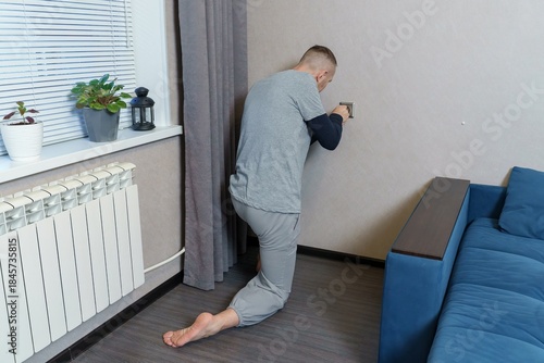 Cuadro en lienzo An electrician is fixing a faulty outlet