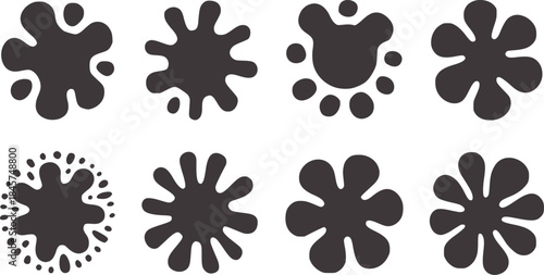 Eight black irregular ink blot shapes white blots