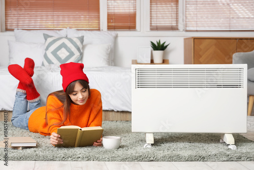 Young woman reading book on...