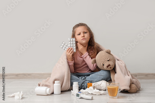 Sick little girl with pills...