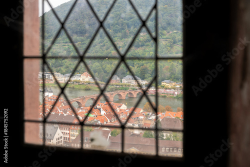 Castle Window View Old Town and Neckar River.A high angle, view of Heidelberg’s old bridge over the Neckar River from Heidelberg Castle.
