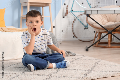 Shocked little boy sitting ...