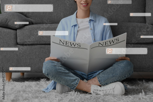 Young woman reading blank n...