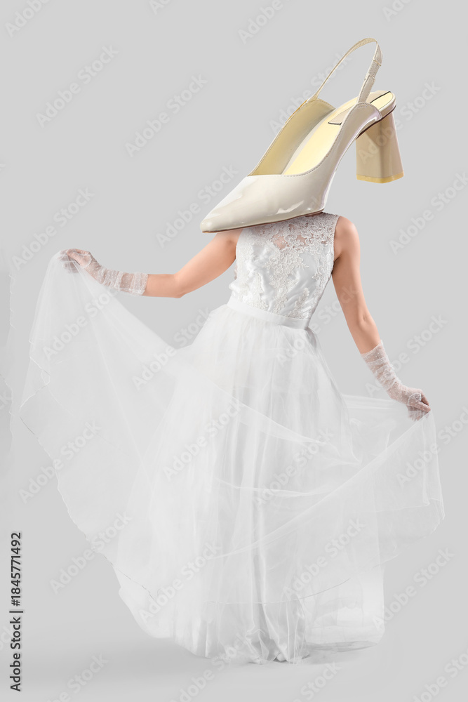 Naklejka premium Beautiful bride in white wedding dress on light background