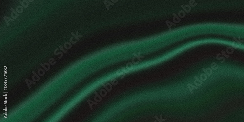 Fotografie A luxurious flowing dark green fabric with soft elegant curves and a smooth velv