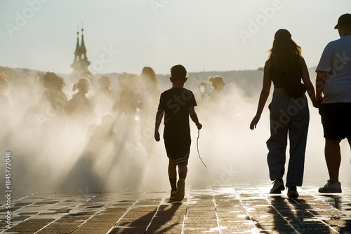 Family walking into cooling fumes in the city
