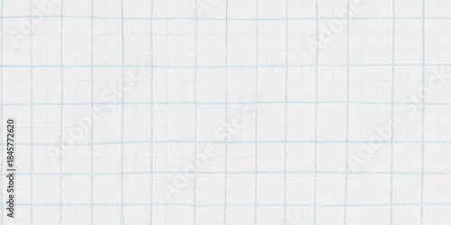 A close up view of a white paper with a faint blue grid pattern ideal for notes and sketches