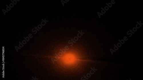 Bright light in an orange energy ball. abstract particle explosions, plasma vortexes  4K loop on dark background for technology and sci-fi videos.