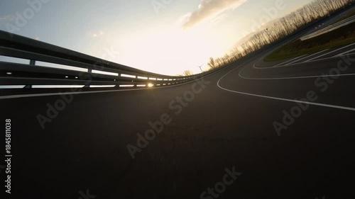 driving a Race Car on a racetrack on a sunny day. POV view
