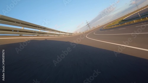 driving a Race Car on a racetrack on a sunny day. POV view