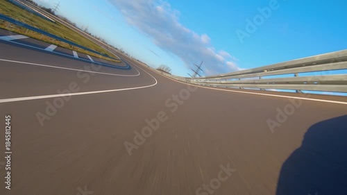 driving a Race Car on a racetrack on a sunny day. POV view