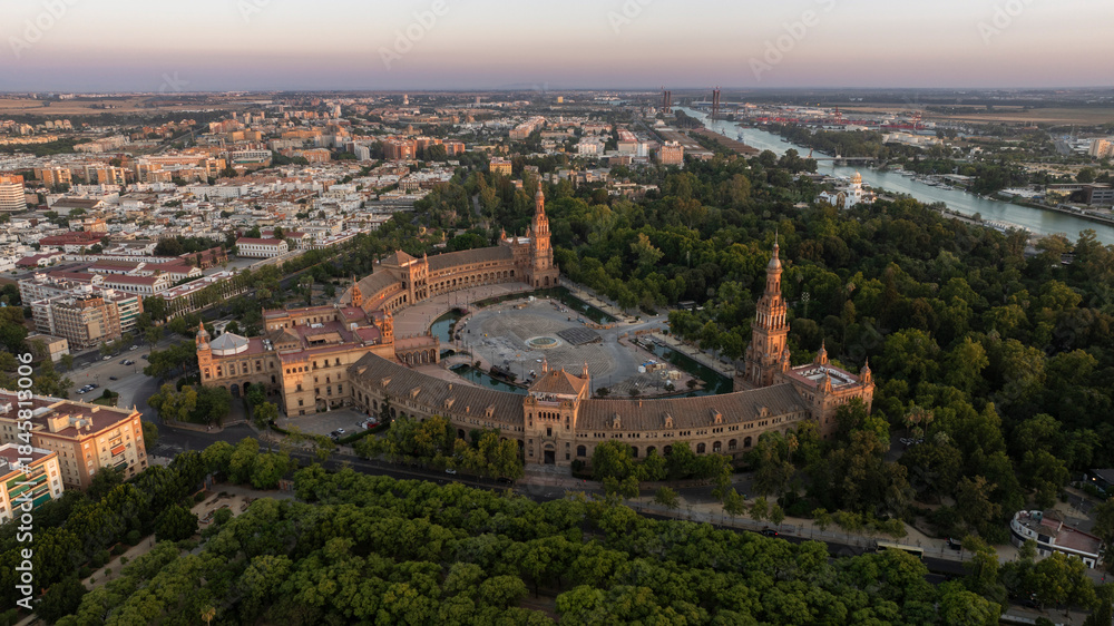 Fototapeta premium Sunset aerial view of historic architecture and the Guadalquivir River of the Sur district of Seville, Andalusia, Spain.