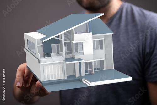 A person holding a model ho...