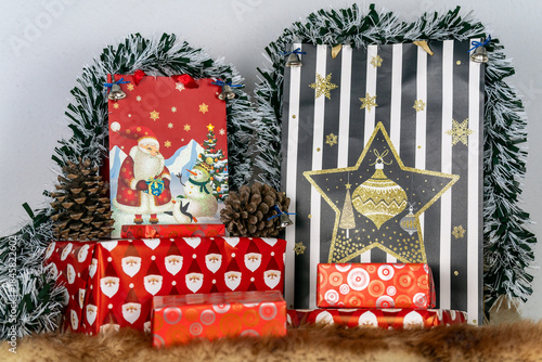 an image of a selection of Christmas gifts in a selection of festive wrappings and tinsel 