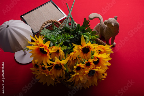 Minimal floral arrangement on red surface