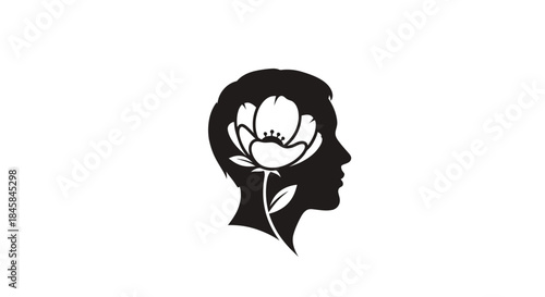 Silhouette of a human head with a blooming flower inside symbolizing growth and thought.