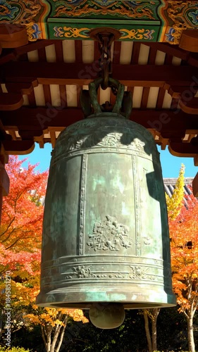 Bronze Bell Hanging at Japanese Temple With Autumn Foliage