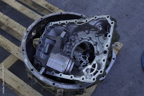 Transmission housing. Clutch housing. Transmission repair and maintenance. Disassembled transmission housing of a heavy-duty truck on a wooden pallet. Internal components of a heavy-duty truck.