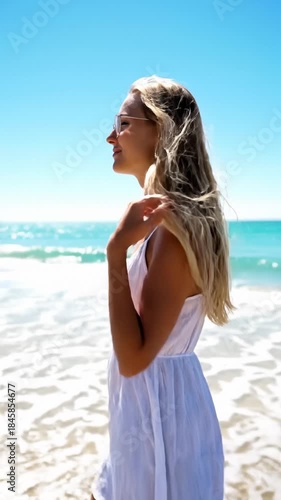 Woman Adjusting Hair by the Ocean in Summer