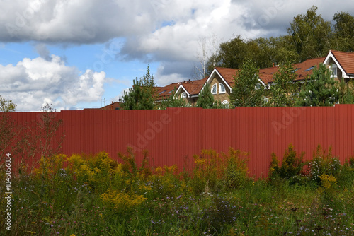Behind the fence - brick house in the architectural style - classic European or English style