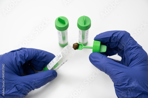 Person collecting stool sample for parasite analysis