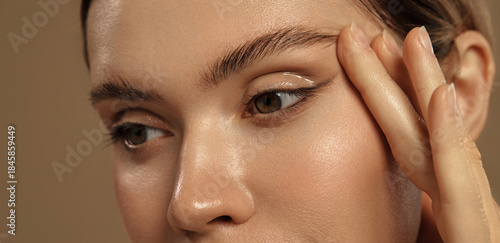 Close-up of female eye with glossy eyeliner and perfect skin texture