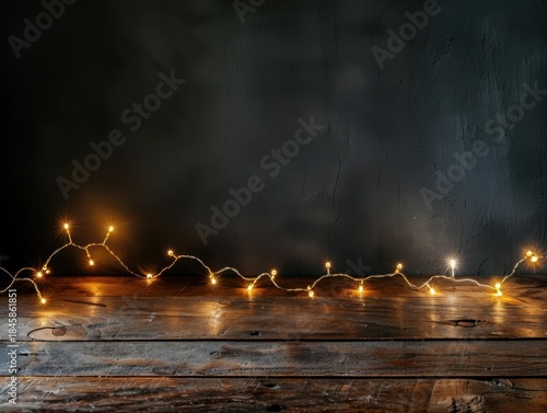 Glowing golden garland on black backdrop, perfect for seasonal marketing, product displays, or holiday card templates