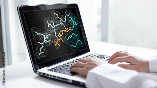 Tableau sur toile A scientist analyzes molecular simulation results and protein drug interactions on a laptop screen to develop new pharmaceutical drugs in a laboratory