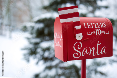 Santa's Mailbox in Snowy Scene. Red mailbox for letters to Santa, set in a snowy winter background