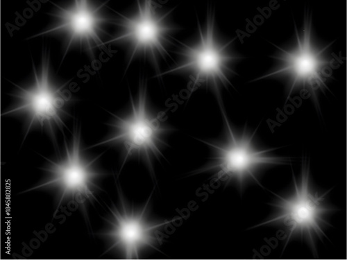 Sparkling white starbursts on black background