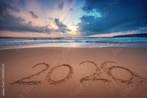 Fototapeta Naklejka Na Ścianę i Meble -  Happy New Year 2026 text on the sea sand and wave on the beach shore
