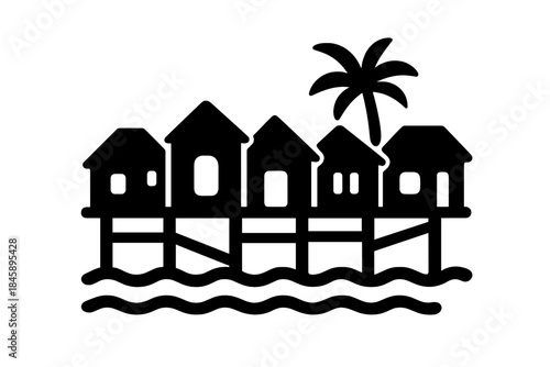 Tropical resort bungalows built on stilts over the ocean waves with a palm tree