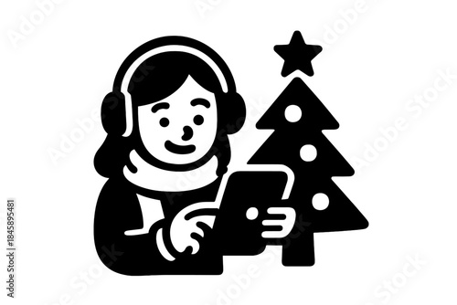 Smiling person with headphones and scarf using tablet next to decorated Christmas tree