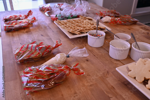 Homemade Christmas sugar cookies set up for themed Daddy Daughter cookie decorating holiday party with sprinkles, icing and coloured sugar