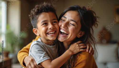 Mother and son embrace with unrestrained joy. Their happy laughter fills room, showing strong family bond and love. Authentic moment of pure connection and fun.