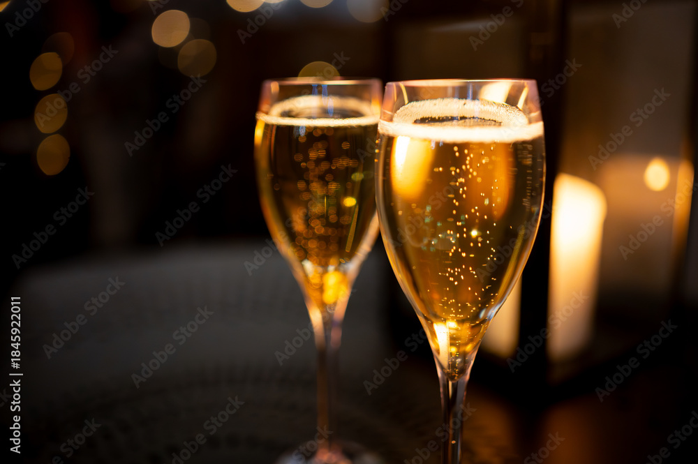 Fototapeta premium Two glasses of french sparkling wine champagne with little bubbles, New Year celebration, wedding or champagne tour with visit of caves, Reims, France