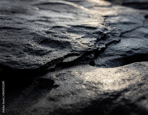 Close Up Of A Rough Dark Textured Surface With Sunlight Reflecting On It Creating A Dramatic Effect