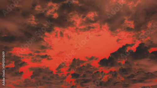 Фотография Dramatic, hellish sky with dark, fiery red clouds framing a glowing center