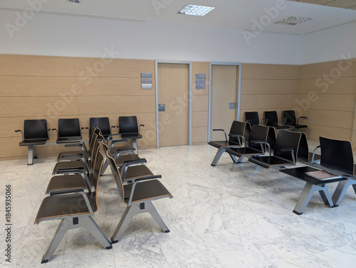 Modern spacious hospital or clinic patients waiting room area with empty chairs. Clean and illuminated medical facility, healthcare, health, contemporary interior architecture, comfort, tranquility.	