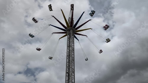 The infernal wheel. Carousels against the sky. Amusement park.