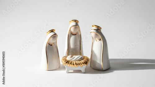 Elegant white and gold nativity scene figures with baby Jesus in manger